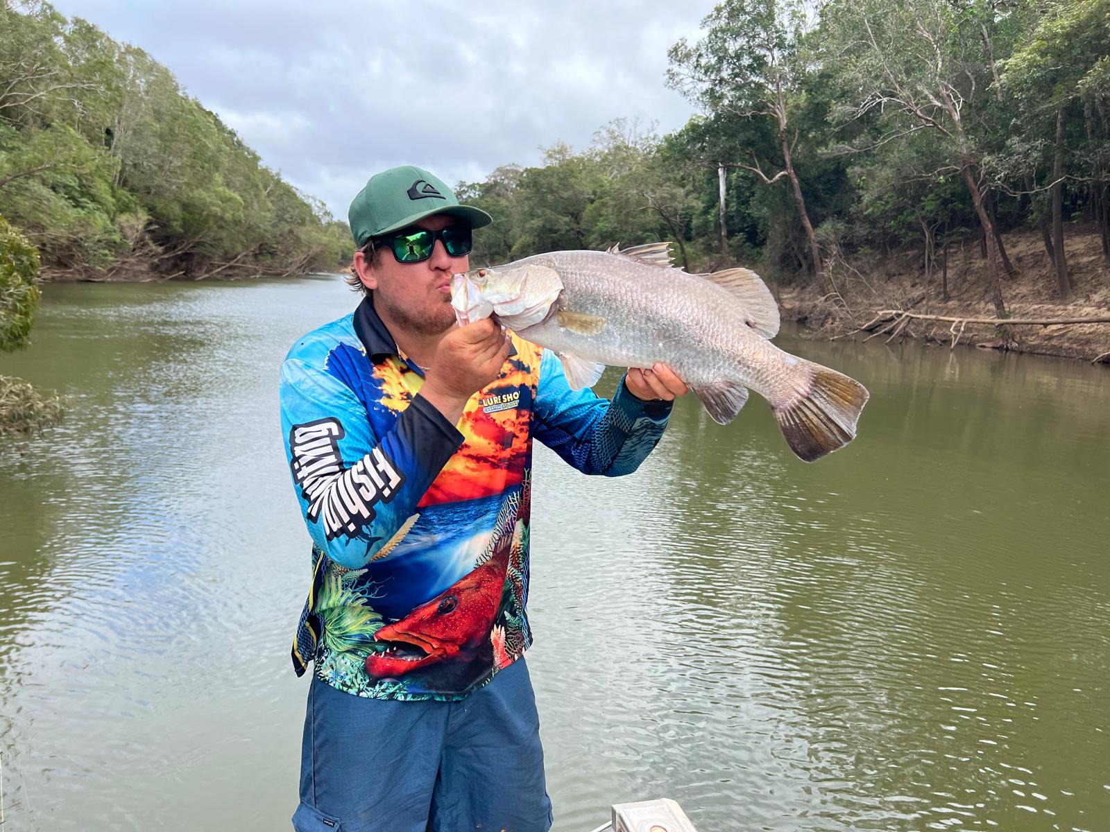 Ant Healy holding a barramundi in capeyork that he caught
